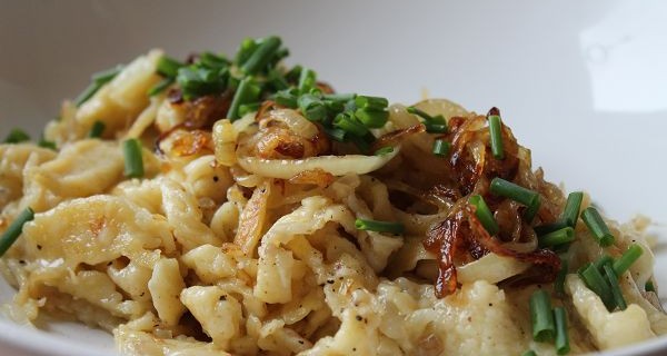 Cheese Spaetzle garnished with braised onions and chives