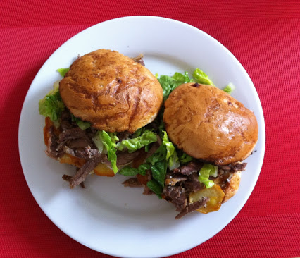 Duck burger with potato slices & salad